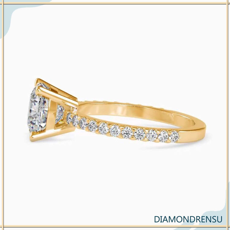Cushio cut diamond with a basket ring setting and pave engagement band.
