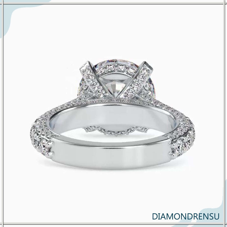 Prong setting engagement ring with pave diamond band.
