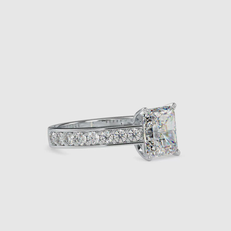 A radiant cut moissanite engagement ring featuring a pave ring setting for added sparkle.
