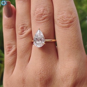 A stunning pear-shaped ring with a 2-carat hidden halo and a classic 3-prong engagement ring setting.
