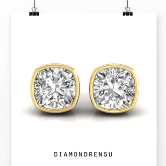 Bezel set diamond earrings featuring cushion cut diamonds for a modern and luxurious style.
