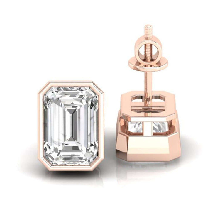 Stunning emerald cut diamond earrings set in a bezel design for a timeless look.
