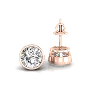 Gleaming white gold earrings featuring bezel set diamond studs perfect for any occasion.
