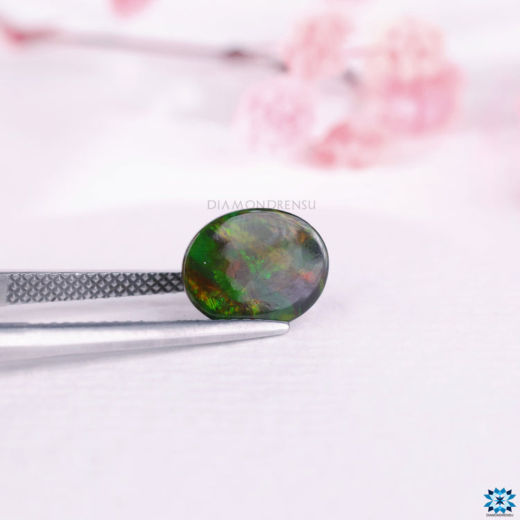 Opal the gemstone used in October birthstone jewelry shown here in oval shape and natural color.
