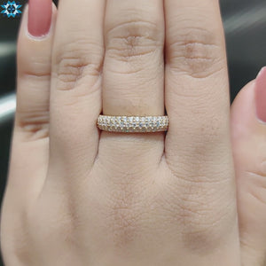 Round moissanite wedding band with sparkling gemstones.