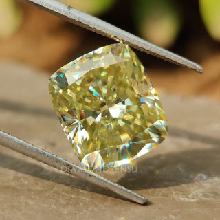 Greenish Yellow Elongated Cushion Cut shown as a loose moissanite from Diamondresnu.
