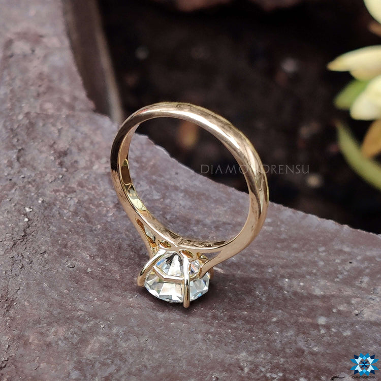 Round solitaire engagement ring showcasing a sparkling diamond with elegant simplicity.
