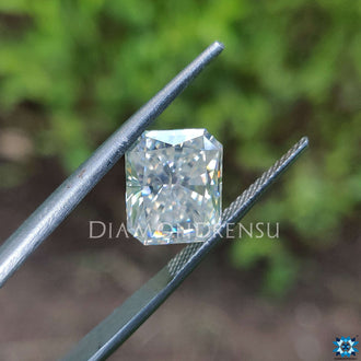 3.65 carat moissanite glowing near radiant cut moissanite loose stone.
