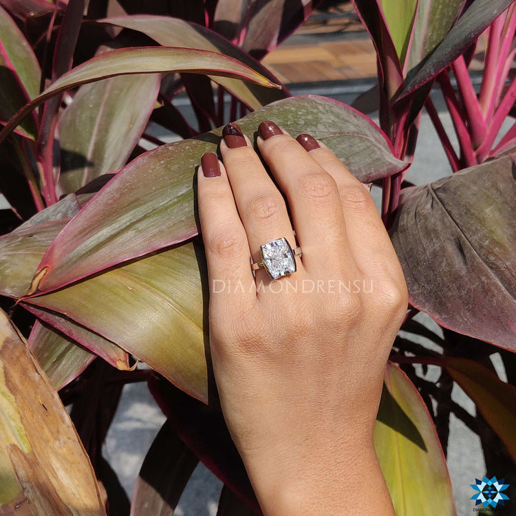 Contemporary half bezel ring with a sleek cushion design.