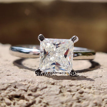 A stunning princess cut engagement ring showcased in a luxurious jewellery box.