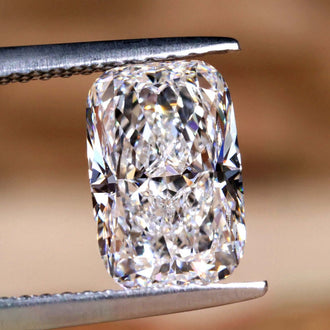 An elongated cushion cut diamond shines with IGI certified lab grown brilliance.

