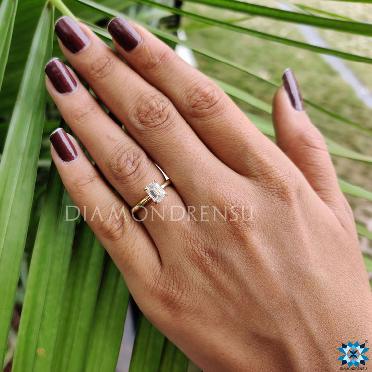 Solitaire emerald cut ring designed for everyday wear.
