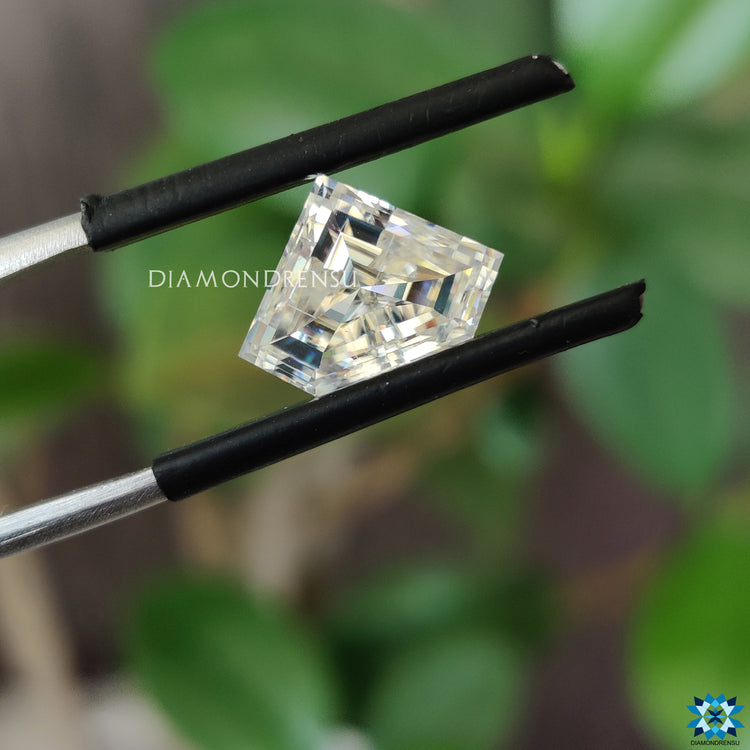 Moissanite loose stone glowing beside 2.36 carat moissanite.
