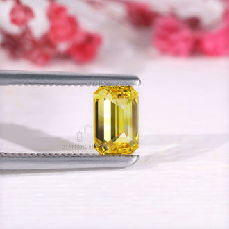 Loose emerald cut diamond IGI certified yellow stone.
