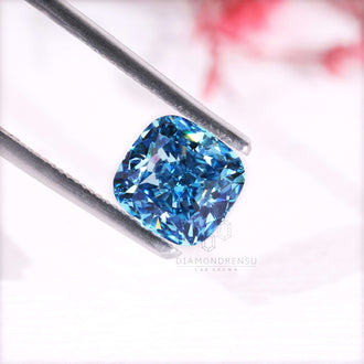 A 2.7 carat diamond in cushion cut with vivid blue lab grown brilliance.
