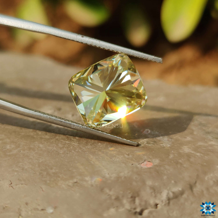 Greenish Yellow Cushion Cut shown as a single moissanite stone.
