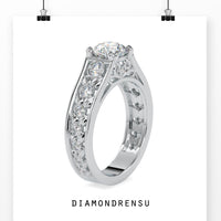 Round diamond ring with filigree details and peekaboo diamond accents.
