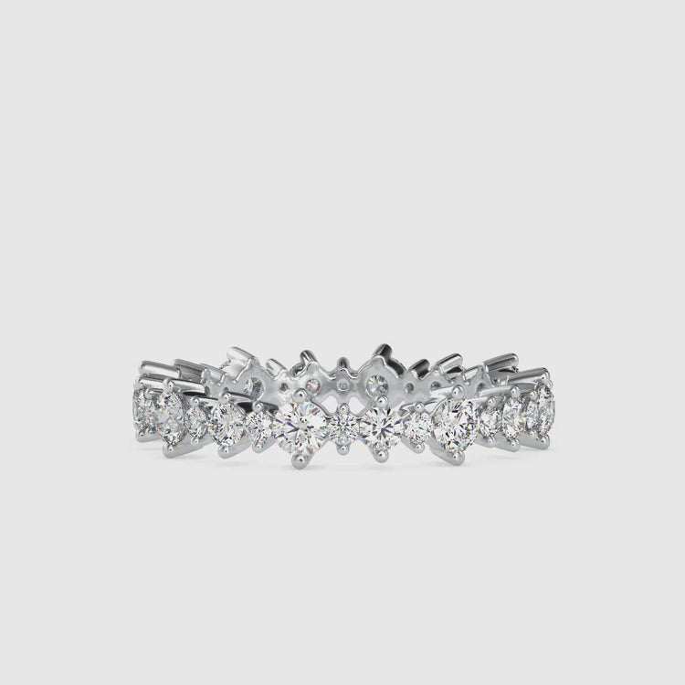 White gold eternity band with round cut diamond and shared prong 
design for women.