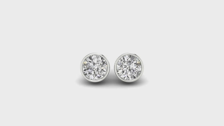 Round bezel diamond earrings, crafted with handmade jewelry expertise for lasting quality.

