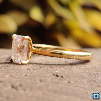 Moissanite emerald cut ring with a minimalist solitaire setting.
