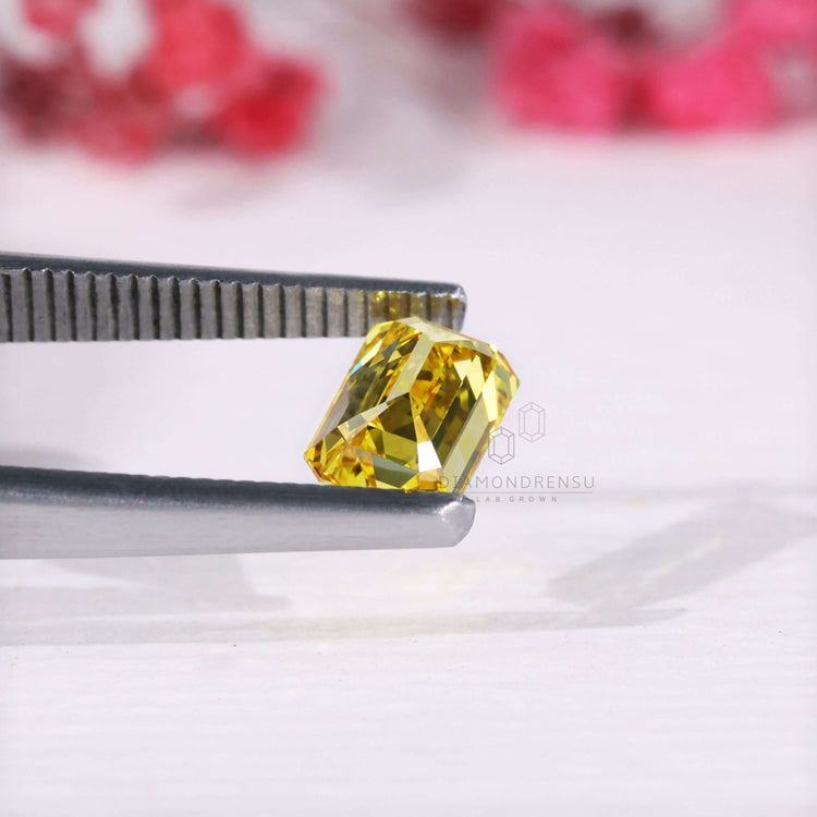 Loose lab grown yellow diamond emerald cut shape.
