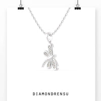 The round gold pendant adds a classic, refined touch.
