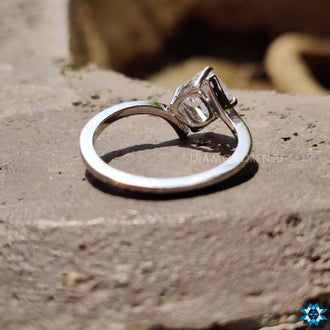 An elegant gold bypass ring with a sleek, minimalist style, glimmering under natural light.