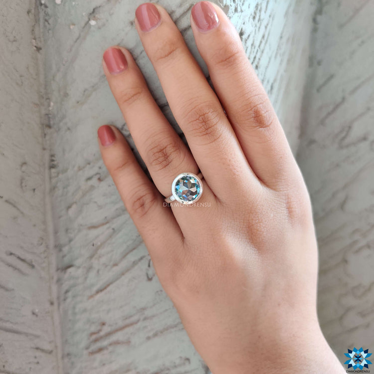 Charming round cut moissanite engagement ring set in a stunning white gold band.
