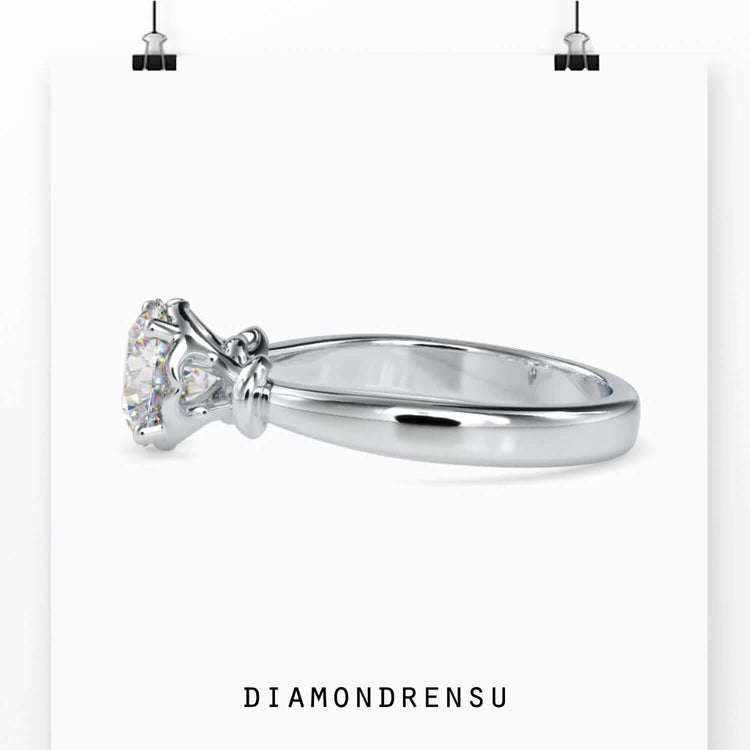 Unique infinity twist wedding ring with a round solitaire diamond.