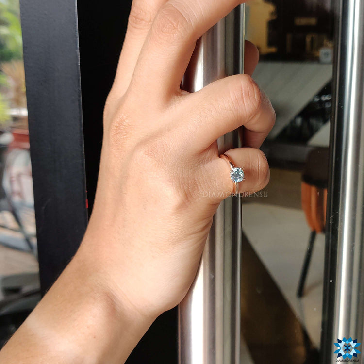 Sophisticated diamondrensu engagement ring with blue moissanite.