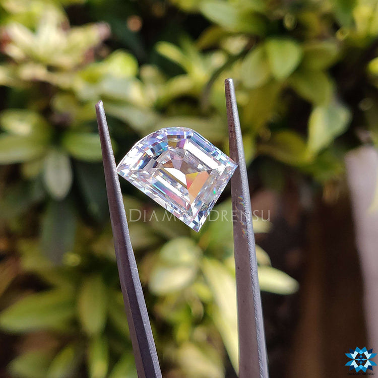 Loose moissanite in antique cut featuring elephant tooth shape and near colorless brilliance.
