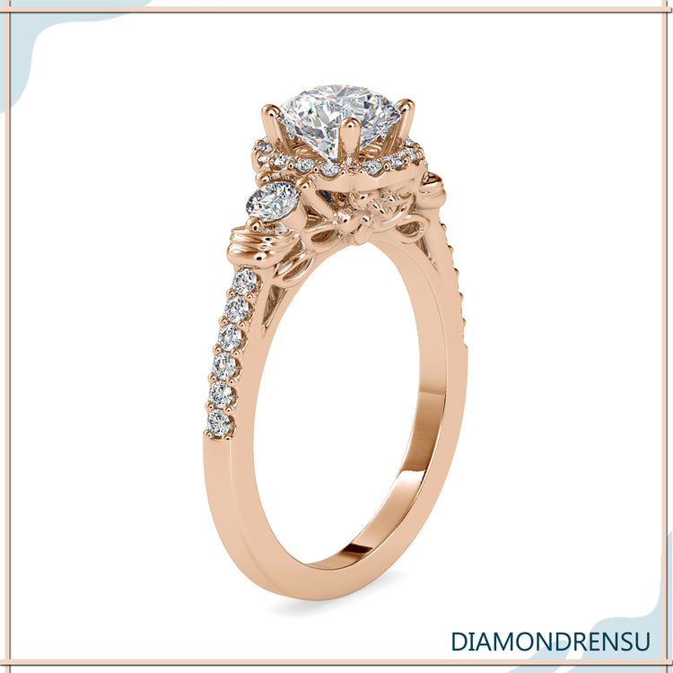 Floral diamond ring with a round diamond engagement center stone.
