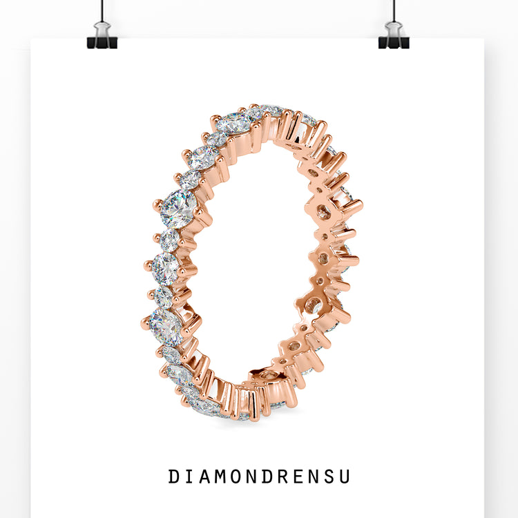 Rose gold wedding band featuring a round cut diamond design and handmade craftsmanship.
