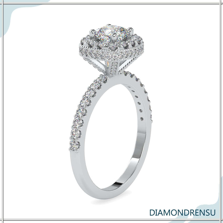 Handmade jewelry featuring a cushion cut halo engagement ring with a diamond prong basket setting.