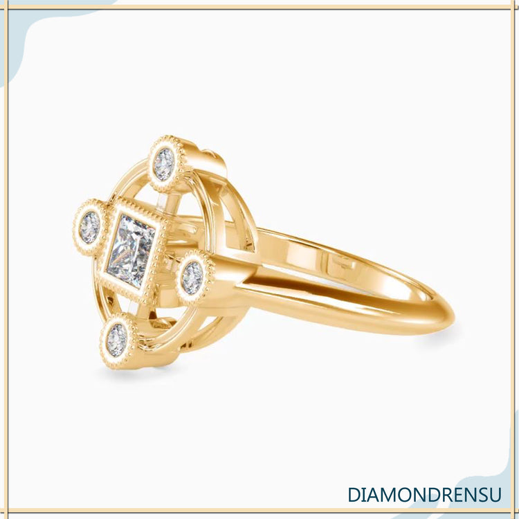 Princess cut engagement ring with side stones in yellow gold
