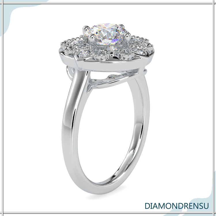 Round diamond engagement ring in white gold with a vintage art deco design
