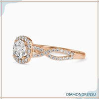 Pave diamond ring with a twisted band and halo setting.
