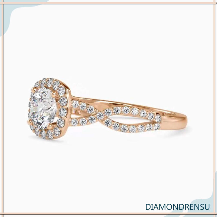 Pave diamond ring with a twisted band and halo setting.
