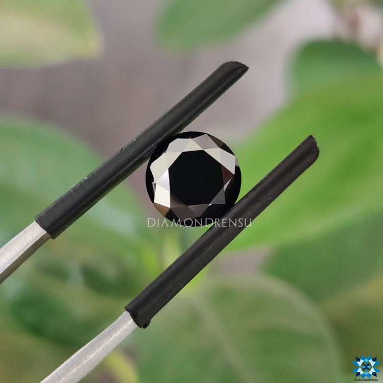 1.35 carat moissanite shining near black moissanite.