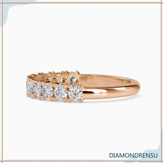 Double prong wedding band with round cut diamonds in a shared prong setting.
