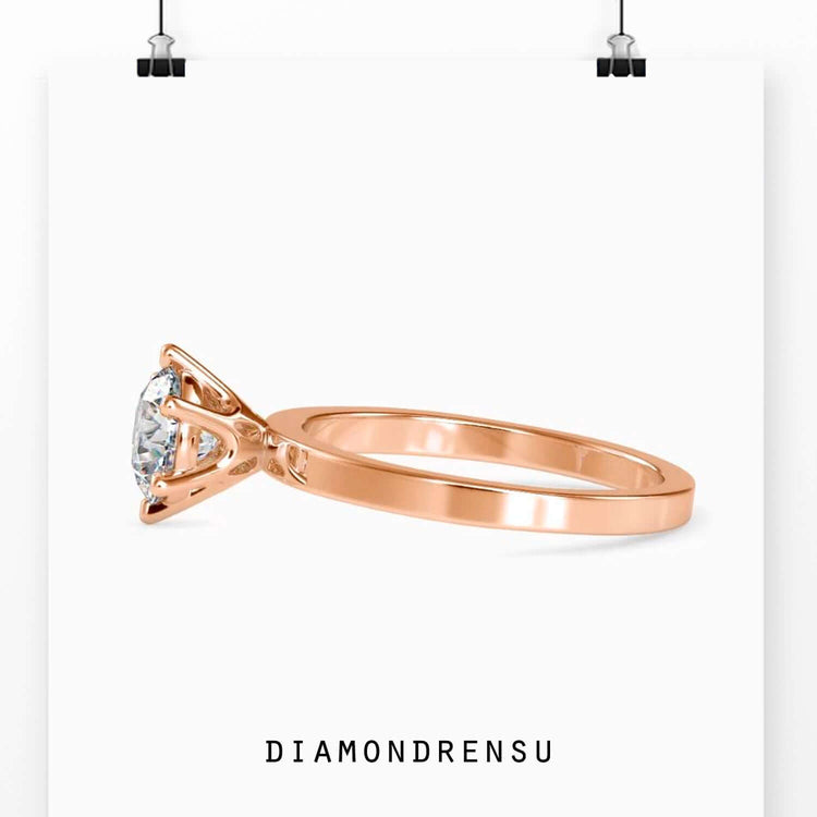 Solitaire diamond engagement ring with a 1 carat diamond and a round gold diamond ring design.