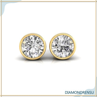 Stylish round bezel diamond earrings in white gold for a contemporary look.
