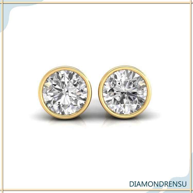 Stylish round bezel diamond earrings in white gold for a contemporary look.
