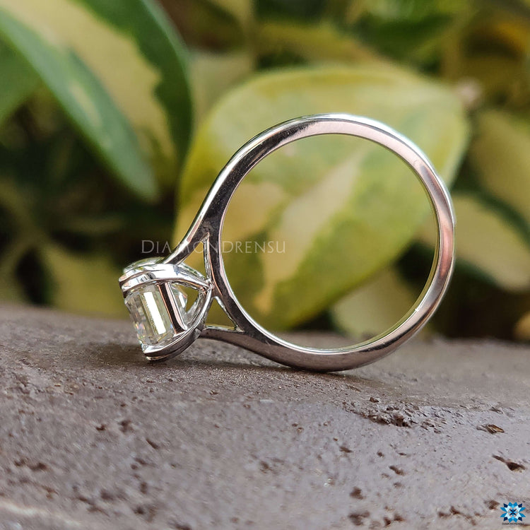 Sparkling moissanite emerald cut engagement ring design.
