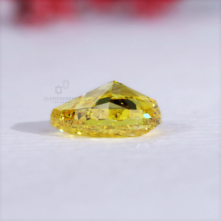 A yellow pear cut diamond shines as a 1.10 carat lab grown loose stone.
