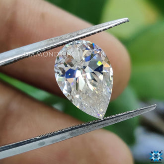 Moissanite loose stone shining near colorless moissanite stone.
