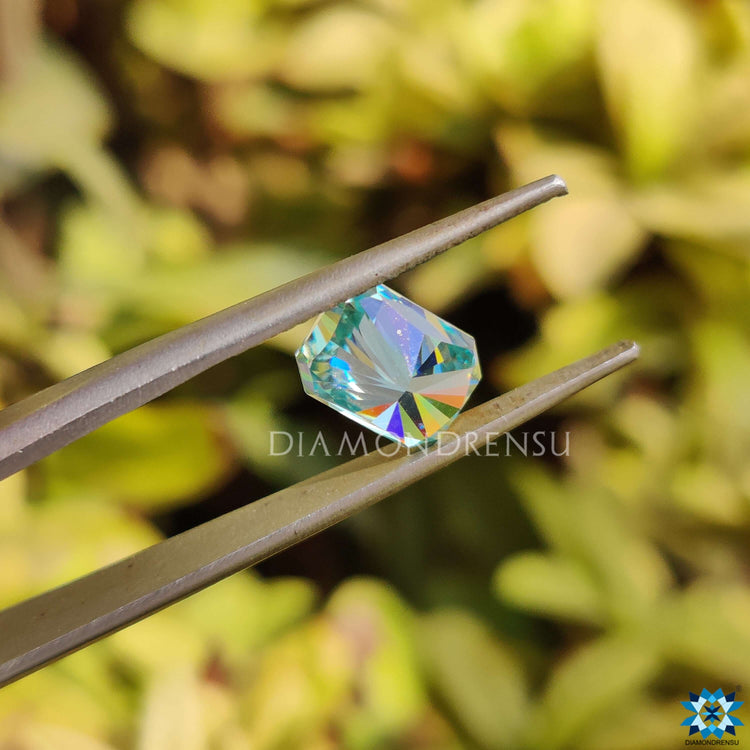 Radiant cut moissanite loose stone in blue shade with a 1.85 carat size.
