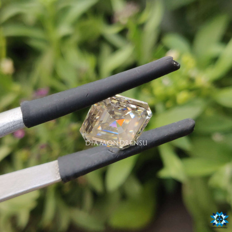 Off white moissanite offered in an asscher cut shape.
