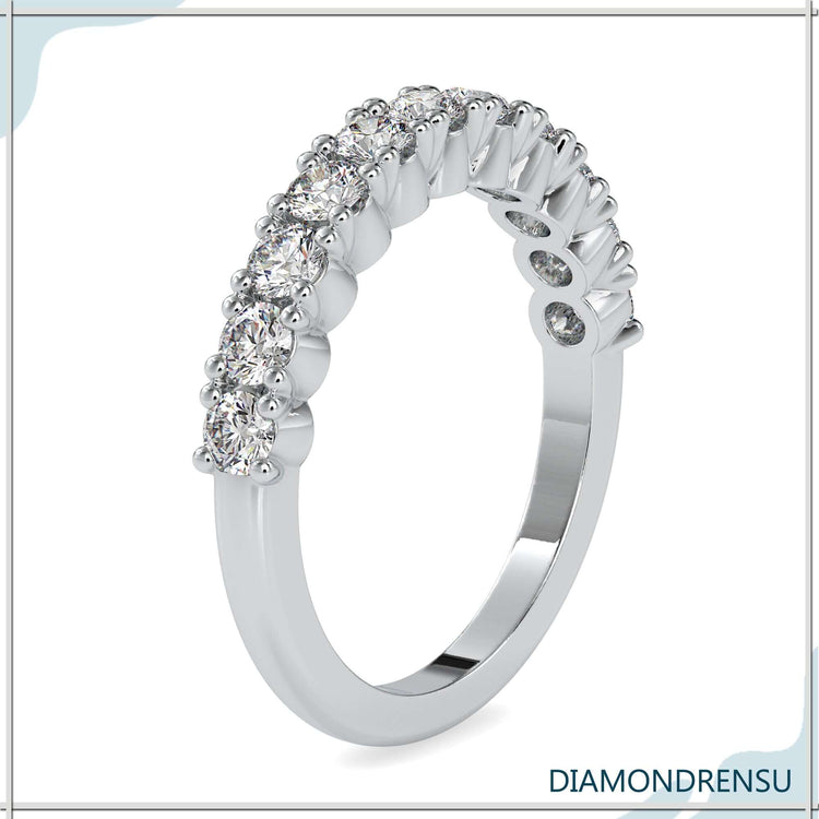 Rose gold wedding band with round brilliant cut shared prong diamonds.
