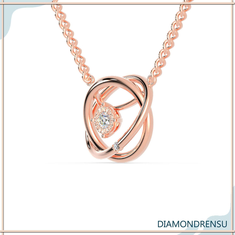 White gold pendant holding a round cut diamond in a handmade jewelry design.

